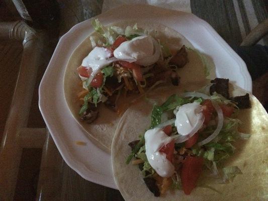 Tacos..., heaven on a plate... prepared by a beautiful blonde Bavarian with chicken, lettuce, onion, tomato, cheese and sour cream.... 