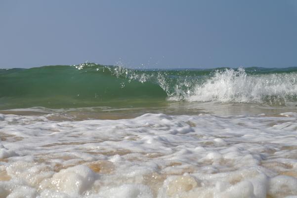 Glassy waves breaking in shallow water under a cloudless blue sky... 