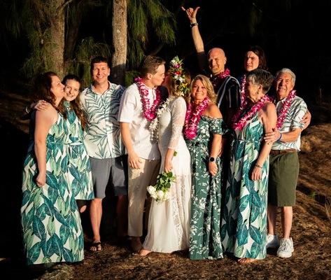 Family photoshoot at the beach here on the garden Island Kauai Hawaii in the middle of the pacific.  Colorful Hawaiian dresses lei around the neck and flower crown Haku in the hair.  